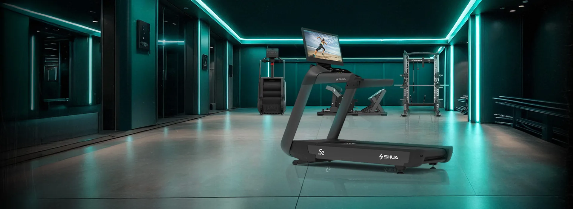 A SHUA treadmill on a gym floor lit in teal, with a rack and benches behind it